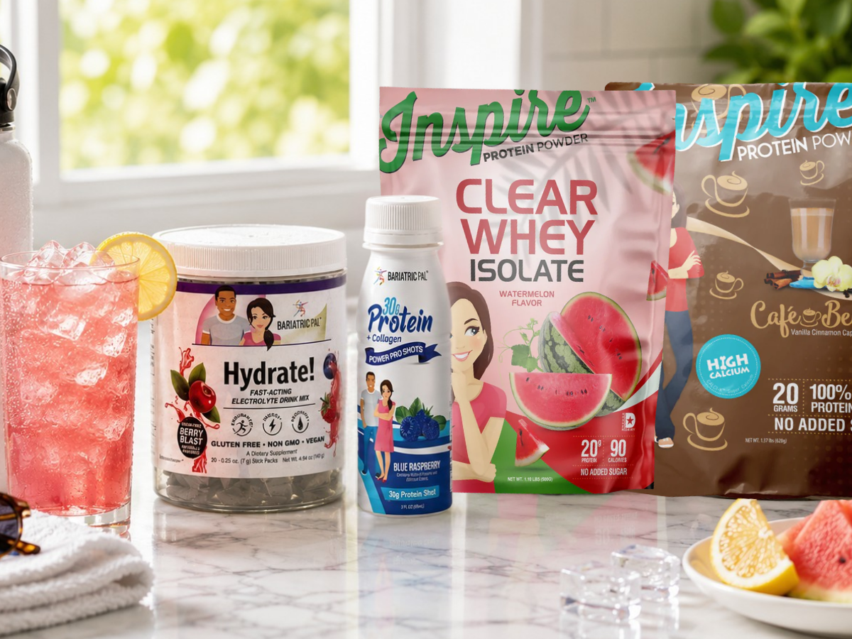 A colorful display of hydration and protein products, including a glass of pink drink with a lemon slice, a container of electrolyte mix, and two protein powder bags, set on a marble countertop.