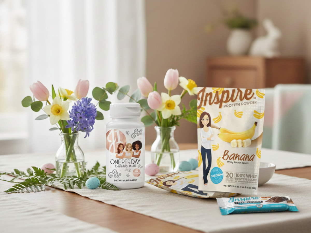 Cozy Easter-themed table with soft spring decor featuring Inspire High-Protein Bars – Caramel Crunch, Inspire Banana Whey Protein, and J1 One-Per-Day Multivitamin Caplets arranged in a calm, inviting setting.