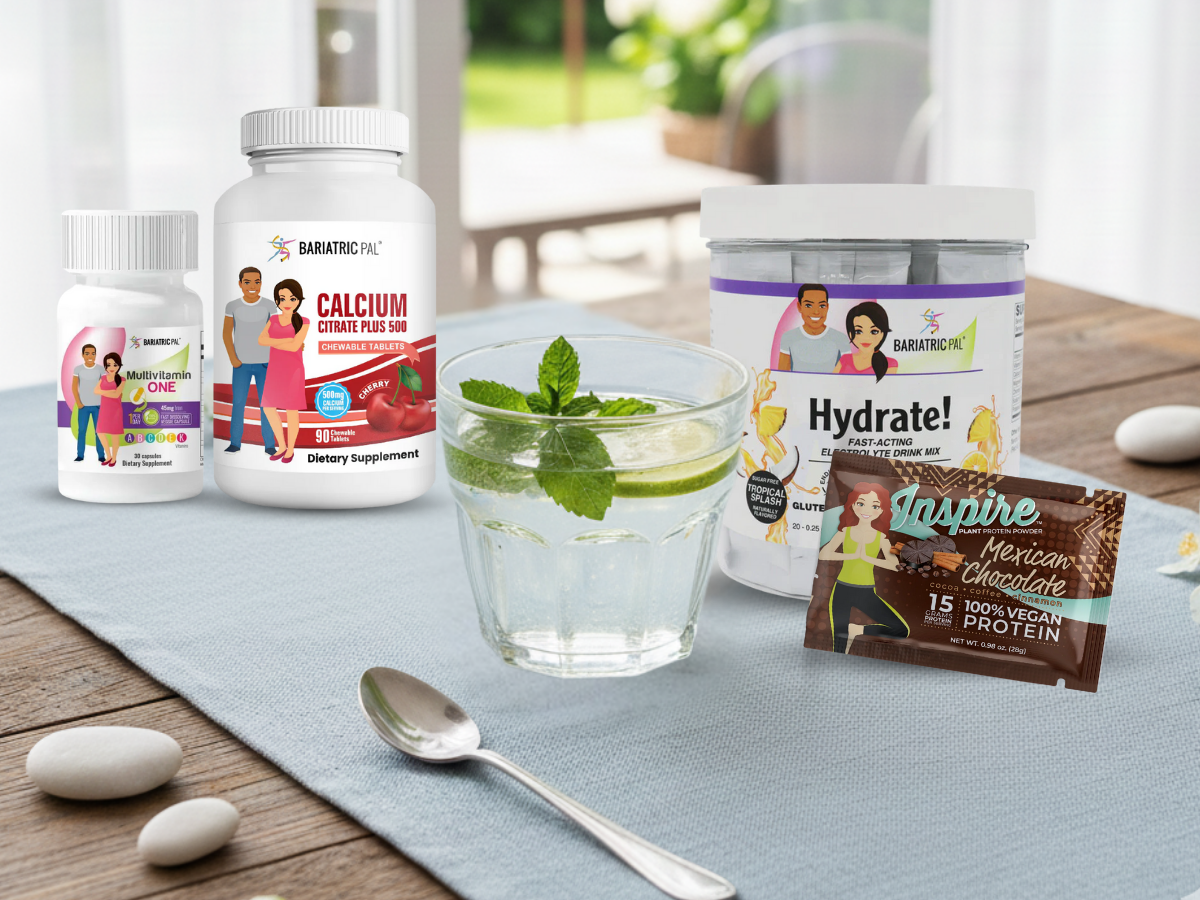 A glass of water with mint sits on a table alongside dietary supplements for bariatric patients, including multivitamins, calcium, and an electrolyte drink mix, in a bright, outdoor setting.