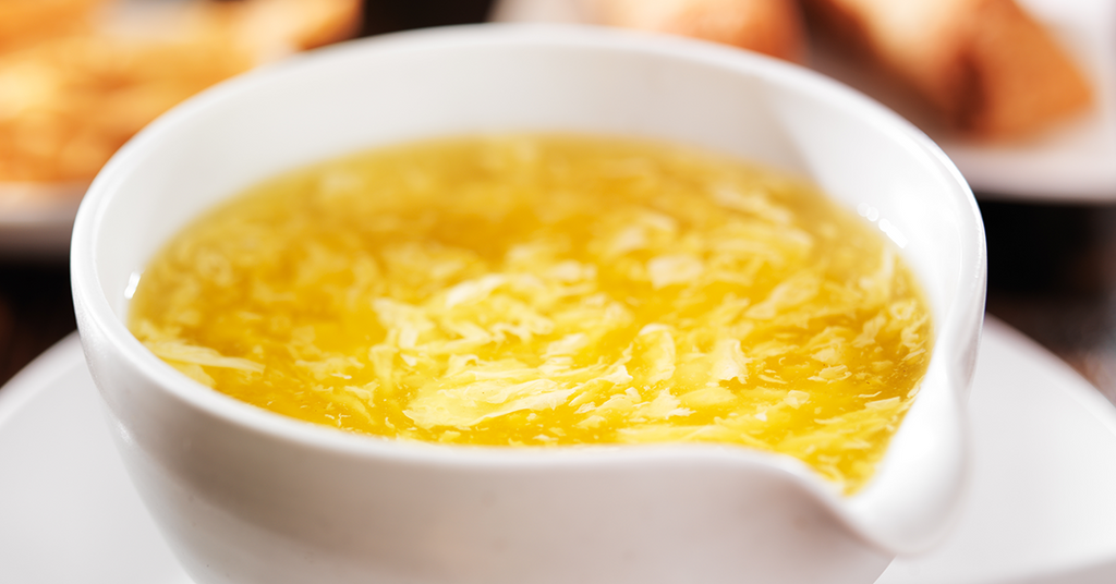 Bariatric soft-food friendly egg-drop soup with corn chowder base, high-protein, cozy winter meal in a bowl.