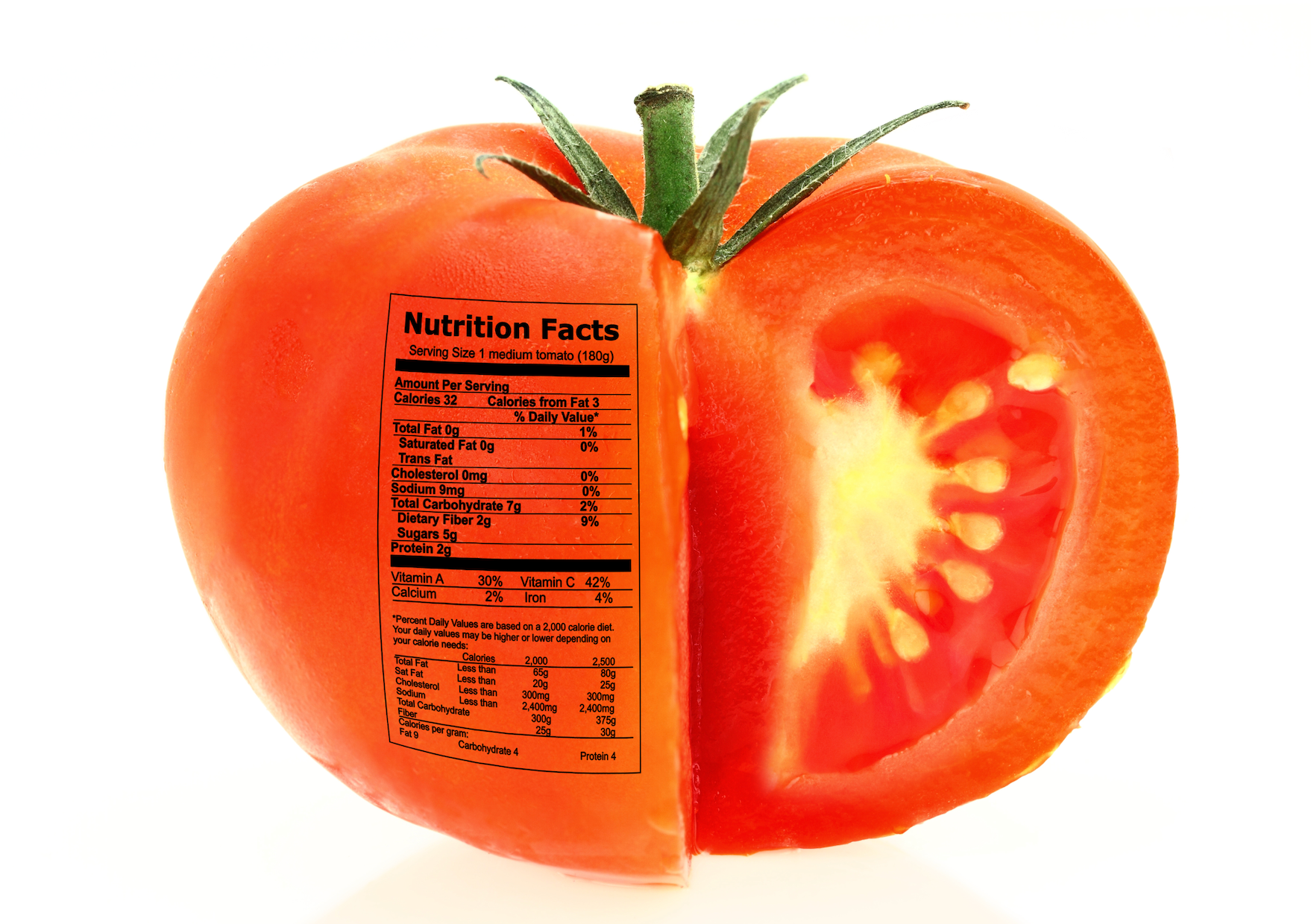 Tomato cut in half with a printed nutrition label on the surface, showing internal seeds and flesh.