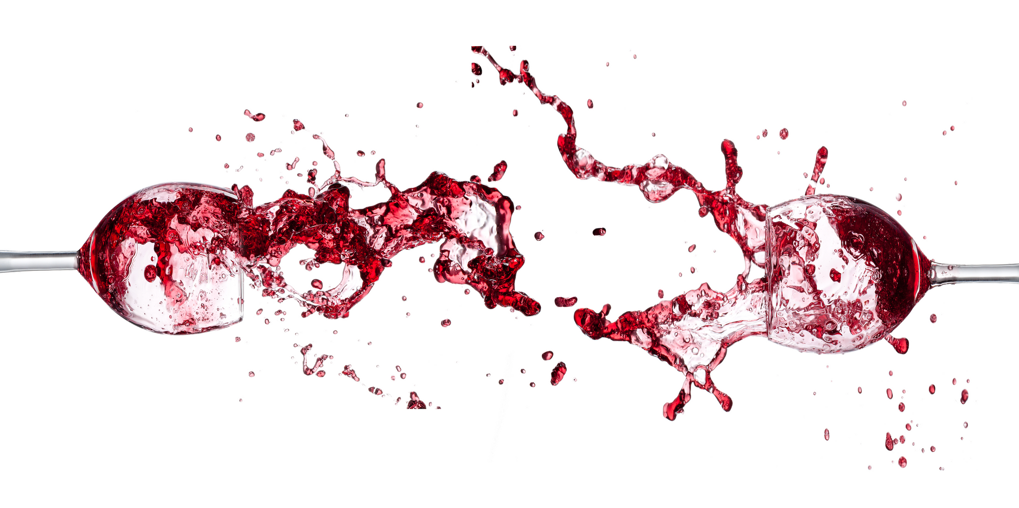 Two wine glasses collide, splashing red wine across a white background.