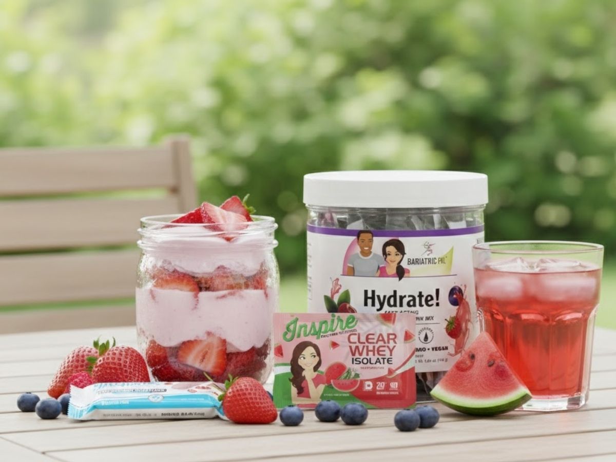 Strawberry yogurt parfait with protein bar, electrolyte drink mix, and clear whey watermelon in a summer setting