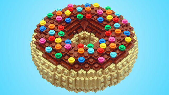 LEGO donut model with brown frosting and colorful round sprinkles on a blue background.