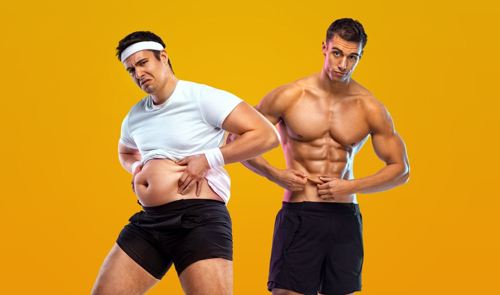 Two men stand side by side against a bright yellow background; one looks frustrated while holding his stomach, and the other confidently shows off his toned physique.