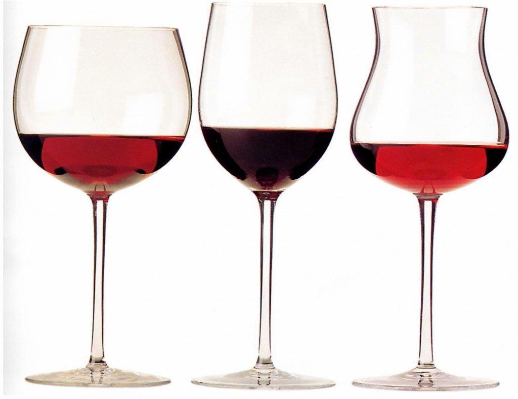 Three wine glasses of different shapes, each partially filled with red wine, arranged side by side.