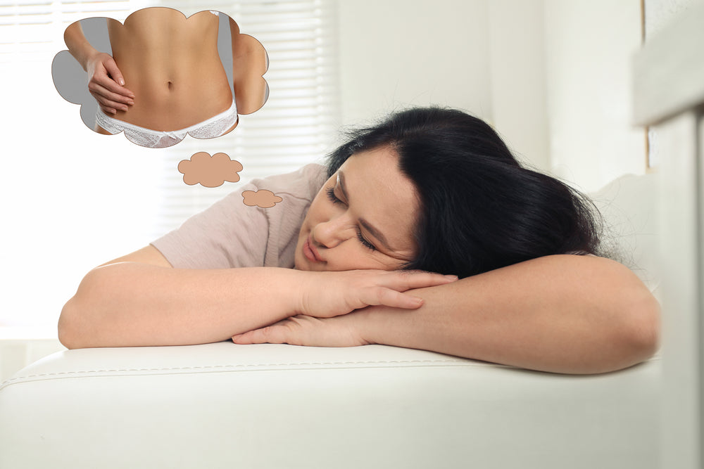 A woman rests her head on her arms on a couch, appearing thoughtful, while a thought bubble shows a hand on a bare midriff and a pair of white underwear, suggesting her contemplation of body image.