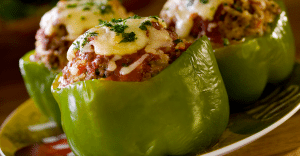 Green bell peppers stuffed with a seasoned filling and topped with melted cheese and herbs.