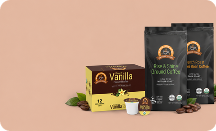 A coffee product lineup on a warm beige background, featuring a vanilla-flavored box, two black coffee bags, a single coffee cup pod, and scattered coffee beans with green leaves. The packaging shows the brand name Coffee Republic.